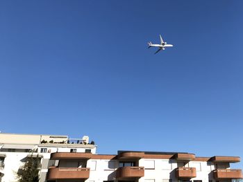 Low angle view of airplane flying against clear sky