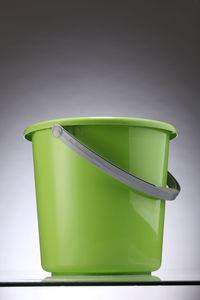 Close-up of bucket against gray background