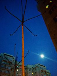 Low angle view of illuminated street light against sky at night