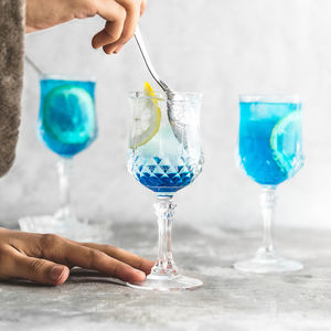 Person hand holding glass of wine glasses