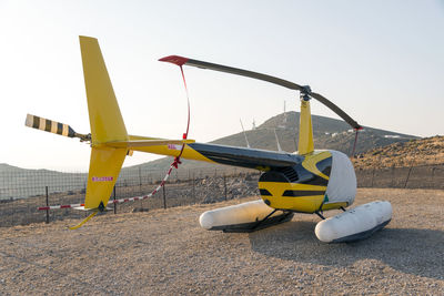 Helicopter on runway against sky