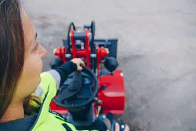 High angle view of woman with machinery at construction site