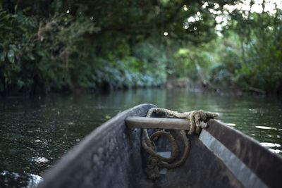 Close-up of rope on bridge over lake