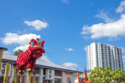 Low angle view of sculpture against buildings