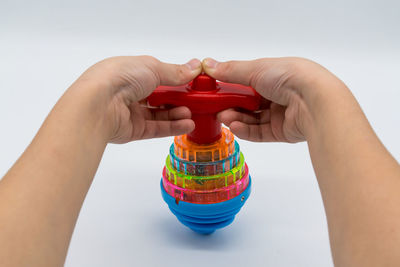 Close-up of hand holding multi colored umbrella