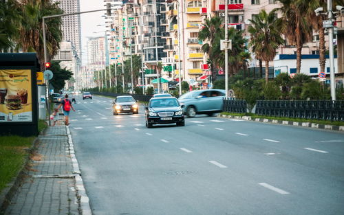 Vehicles on road along buildings