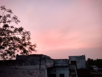 Low angle view of building against sky during sunset