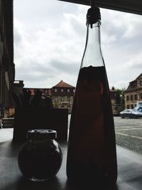 Close-up of beer bottles on table in city