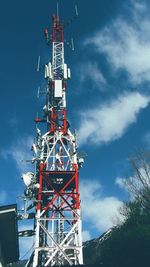 Low angle view of communications tower against sky