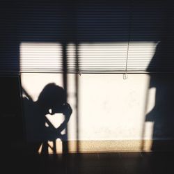 Shadow of hand on tiled floor
