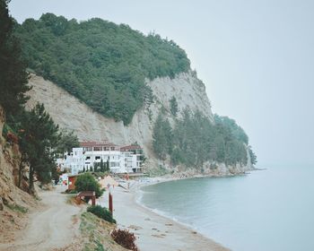 Scenic view of sea and buildings against sky