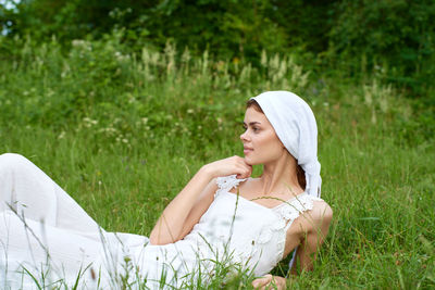 Young woman sitting on field