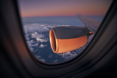 Close-up of airplane wing against sky