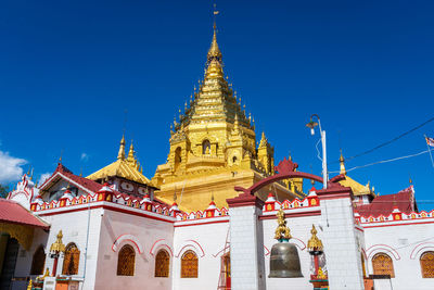 Low angle view of temple building against blue sky