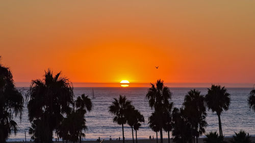 Scenic view of sea against romantic sky at sunset