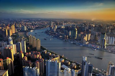 High angle view of city lit up at waterfront