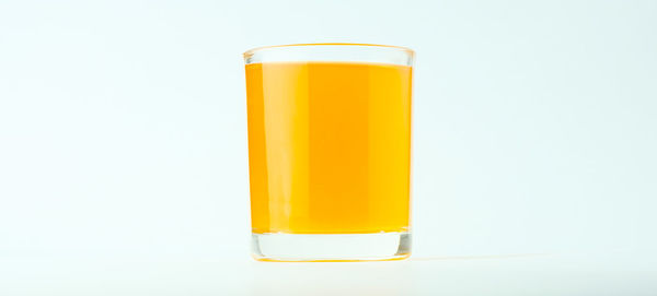 Close-up of yellow glass against white background