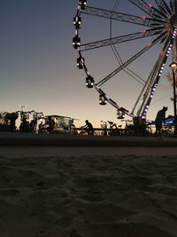 Ferris wheel against sky at dusk
