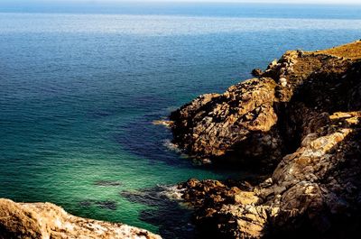 High angle view of rocks at sea shore