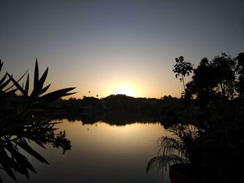 Scenic view of lake against sky during sunset