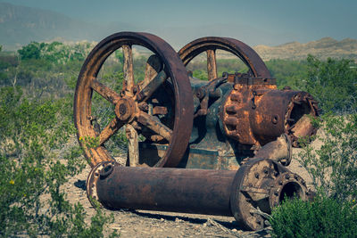 Old rusty wheel on field