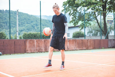Rear view of man playing tennis
