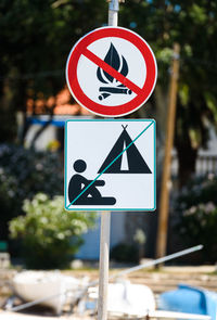 Close-up of road sign against trees