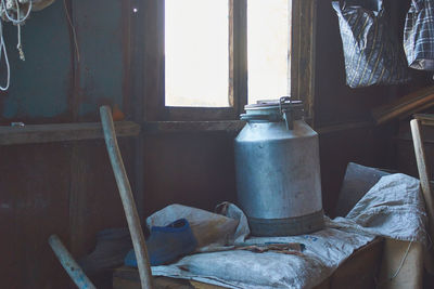 Old wooden table by window at home