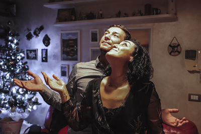 Young woman looking up at home