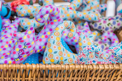  basket full of soft toys of colorful cats in a street souvenir shop