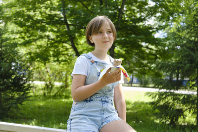Teenage girl on a walk on a summer day in the park to enjoy ice cream