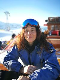 Smiling woman in ski-wear outdoors