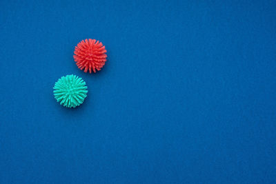 High angle view of multi colored ball on table against blue background