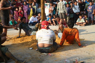 People sitting on street in city