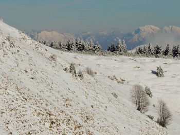 Scenic view of snow covered landscape against sky