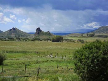 Scenic view of landscape against cloudy sky