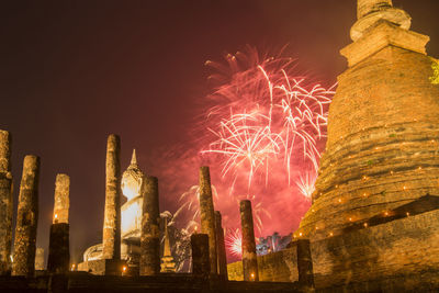 Low angle view of firework display at night