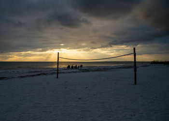 Scenic view of beach against sky during sunset