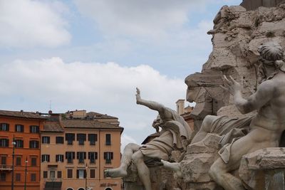 Low angle view of statue against cloudy sky