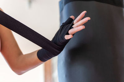 Close-up of woman hand holding black at home