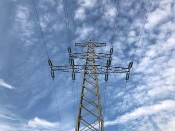 Low angle view of electricity pylon against sky