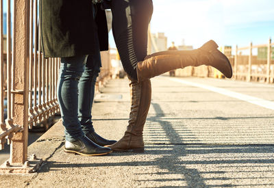 Low section of people walking on street