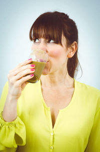 Close-up of young woman drinking drink