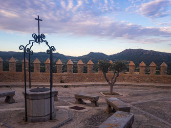 Built structure against mountain range against sky