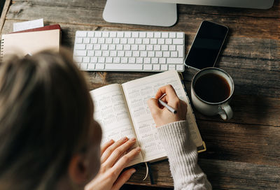 Midsection of woman using laptop on table