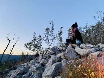 Woman sitting on rock