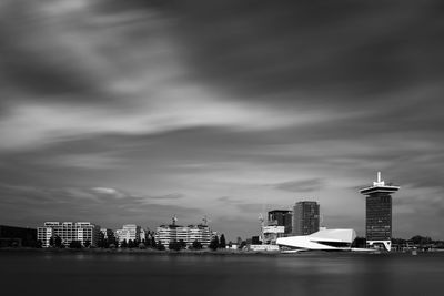 Modern buildings in city against cloudy sky amsterdam skyline eye museum long exposure