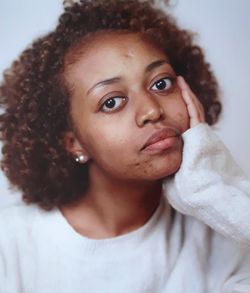 Close-up portrait of young woman at home