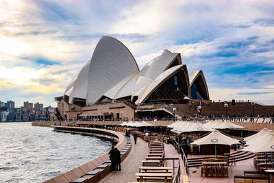 View of cityscape against cloudy sky