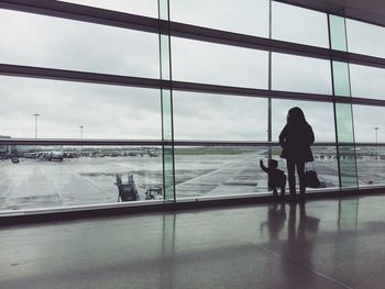 Rear view of man sitting at airport